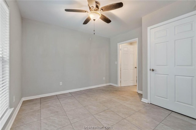 spare room featuring ceiling fan and light tile patterned flooring