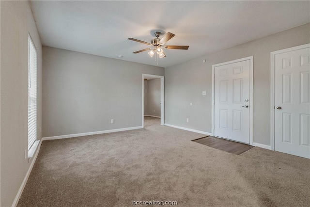 empty room featuring carpet floors and ceiling fan