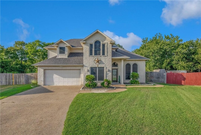 front of property with a front yard and a garage