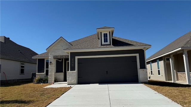 view of front of house featuring a front yard and a garage