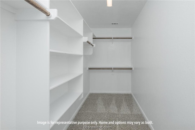 walk in closet featuring light carpet