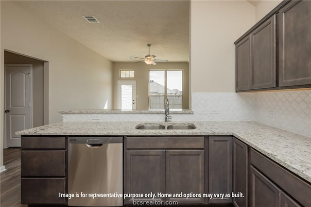 kitchen featuring dishwasher, sink, ceiling fan, dark brown cabinets, and light stone counters