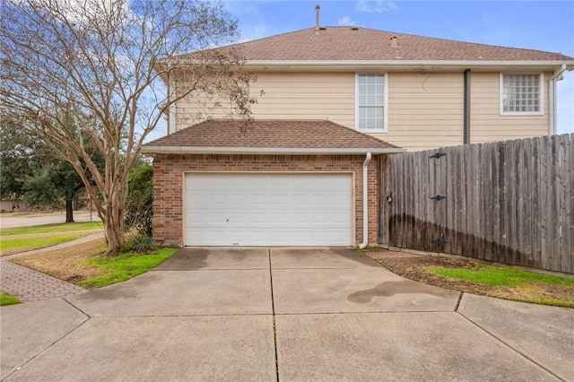1605 Dominik Dr, College Station, TX 77840 - view of home's exterior with driveway, brick siding, a garage, and roof with shingles