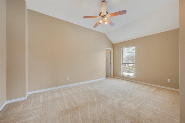 spare room with carpet floors, lofted ceiling, baseboards, and a ceiling fan