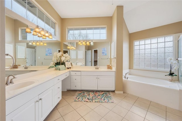 1605 Dominik Dr, College Station, TX 77840 - full bath with a towering ceiling, a garden tub, tile patterned floors, vanity, and a chandelier