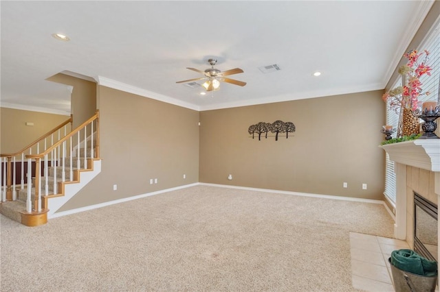 unfurnished living room featuring visible vents, stairs, crown molding, carpet floors, and a fireplace