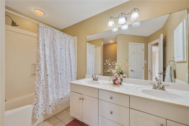 bathroom featuring double vanity, shower / bath combo, a sink, and tile patterned floors