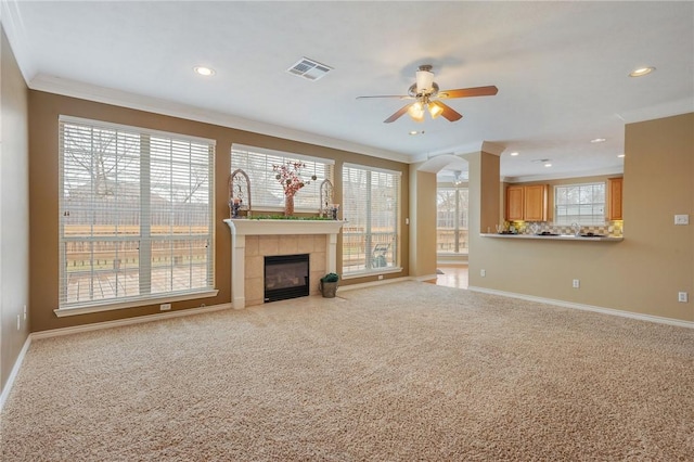 unfurnished living room featuring carpet, visible vents, ceiling fan, and baseboards