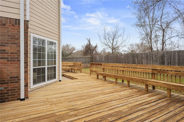 wooden terrace featuring a fenced backyard