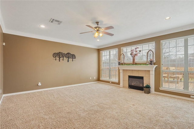 unfurnished living room featuring carpet floors, visible vents, ornamental molding, and a wealth of natural light