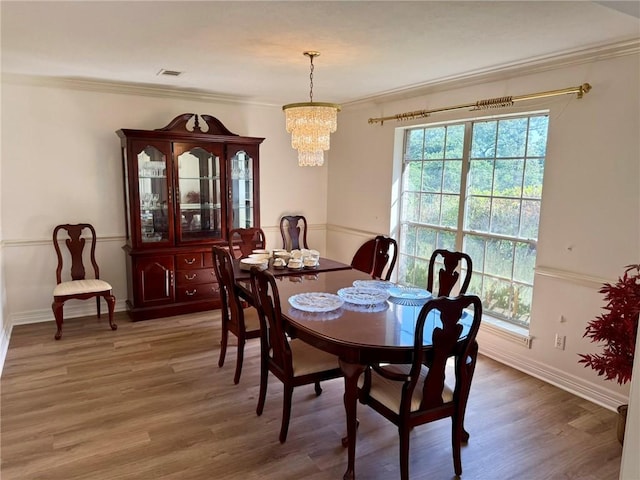 40 Casper Pl, Hilltop Lakes, TX 77871 - dining area with plenty of natural light, a chandelier, ornamental molding, light wood-type flooring, and baseboards