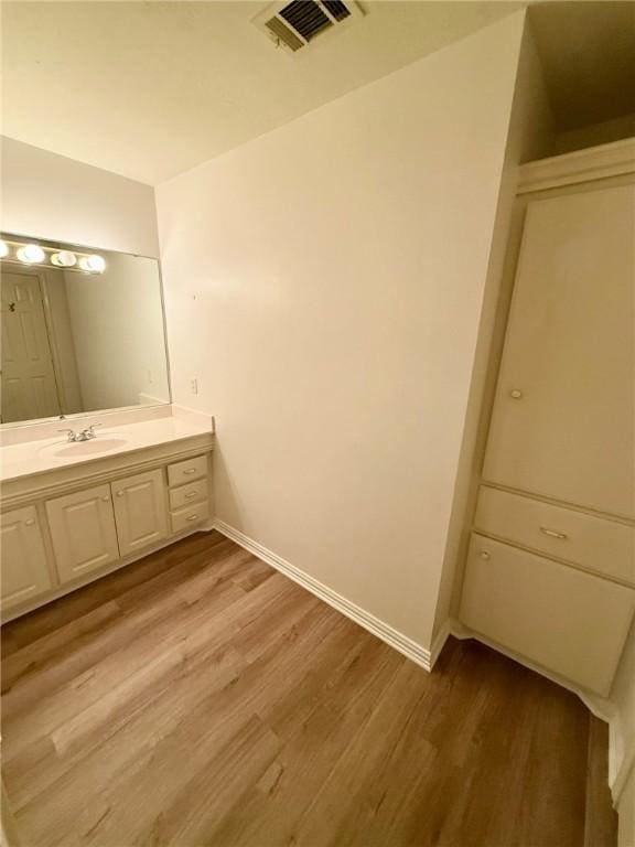 40 Casper Pl, Hilltop Lakes, TX 77871 - bathroom with wood finished floors, baseboards, and vanity