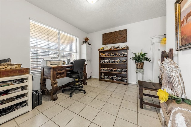 home office featuring light tile patterned flooring and a textured ceiling