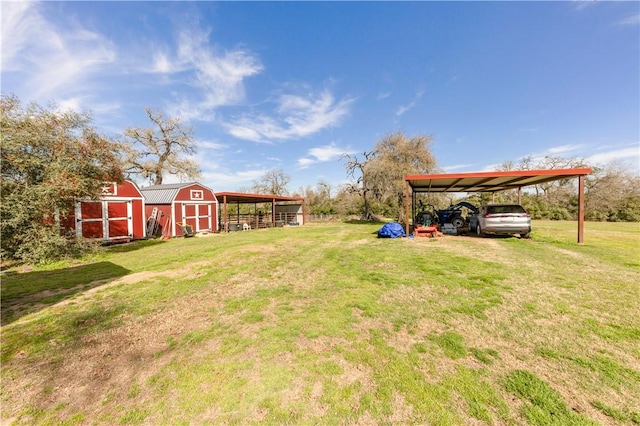 view of yard featuring a detached carport, an outdoor structure, driveway, and a shed