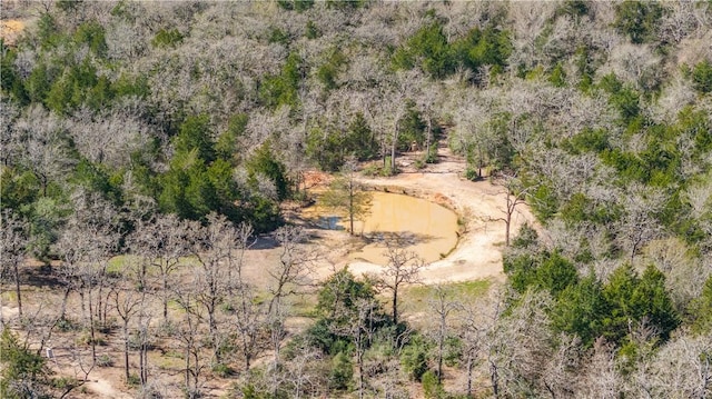 aerial view featuring a wooded view