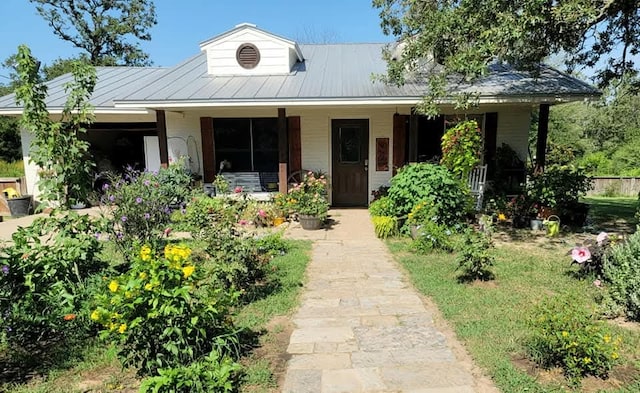 view of front of house with covered porch and metal roof