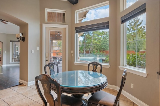 tiled dining area with a wealth of natural light and ceiling fan