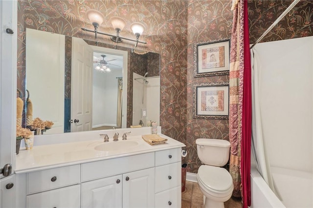 full bathroom featuring ceiling fan, toilet, shower / bathtub combination with curtain, and vanity