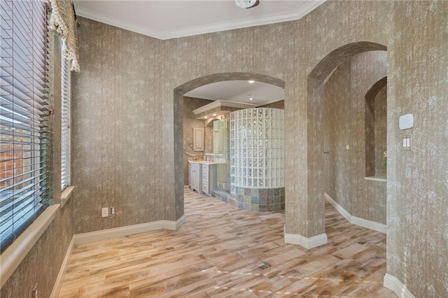 interior space with wood-type flooring and crown molding