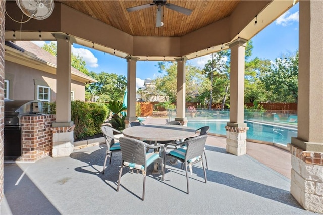 view of patio featuring area for grilling and ceiling fan