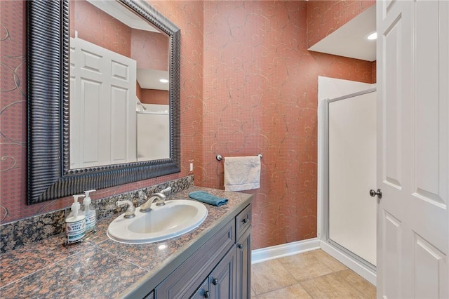 bathroom featuring vanity, tile patterned floors, and a shower with shower door