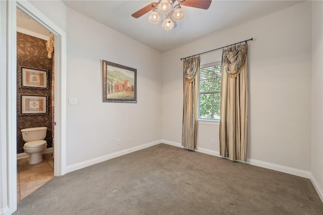 unfurnished room with carpet flooring and ceiling fan