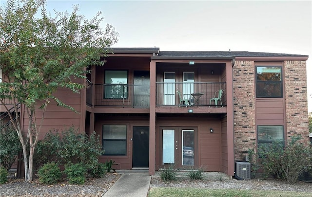 exterior space featuring a balcony, cooling unit, and french doors