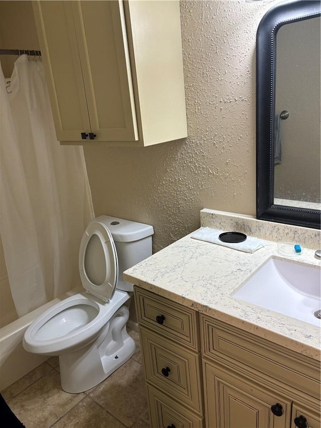 bathroom with tile patterned floors, vanity, toilet, and a shower with curtain