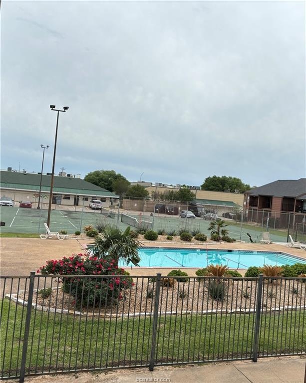 view of swimming pool featuring a lawn