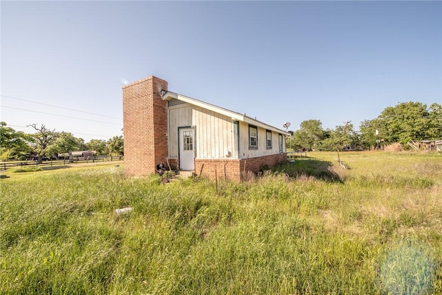 103 Leaning Oaks St, Somerville, TX 77879 - view of side of home featuring a chimney and brick siding