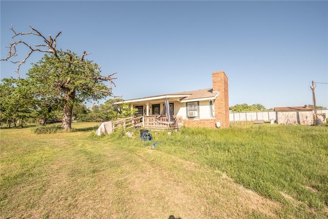 103 Leaning Oaks St, Somerville, TX 77879 - view of front of home with a chimney, a front yard, and fence