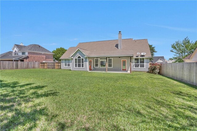 291 Berkley Dr, Montgomery, TX 77356 - rear view of property featuring a fenced backyard, a patio area, a chimney, and ceiling fan