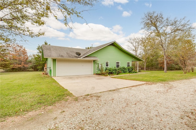 exterior space with a garage, driveway, and a front yard