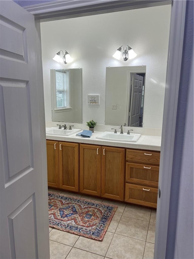 bathroom featuring double vanity, tile patterned flooring, and a sink