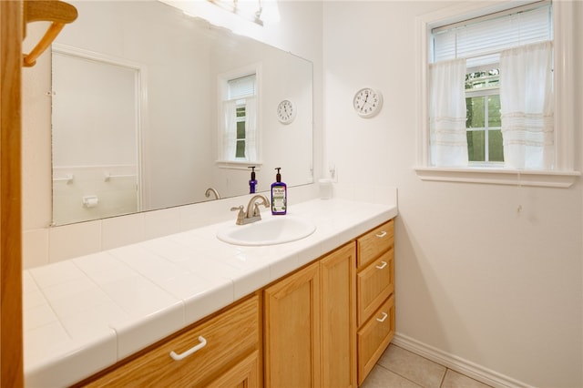 bathroom featuring baseboards, vanity, and tile patterned floors