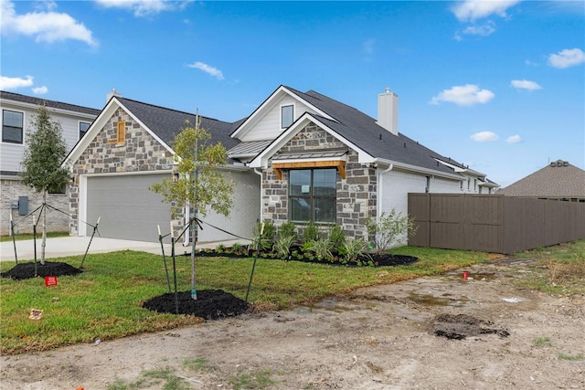 view of front of house featuring a garage and a front yard