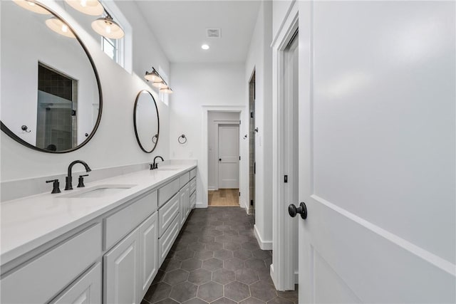 bathroom featuring tile patterned flooring and vanity