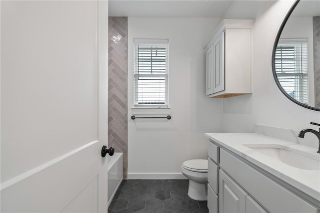 bathroom with tile patterned flooring, vanity, and toilet