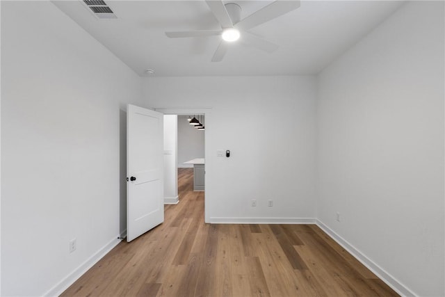 spare room with ceiling fan and light hardwood / wood-style flooring