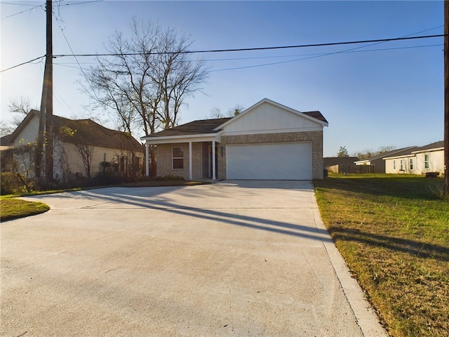 view of front of home with a garage and a front lawn