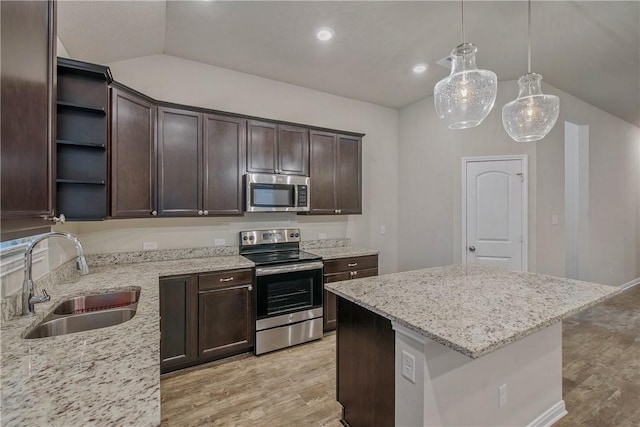 kitchen featuring open shelves, appliances with stainless steel finishes, a sink, and dark brown cabinetry