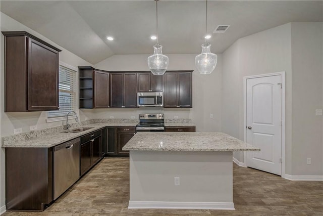 kitchen featuring dark brown cabinetry, a sink, appliances with stainless steel finishes, a center island, and open shelves