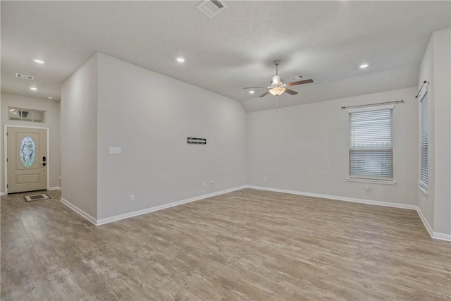 foyer entrance featuring light wood-style flooring, visible vents, ceiling fan, and baseboards