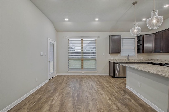 kitchen featuring baseboards, wood finished floors, vaulted ceiling, dark brown cabinets, and stainless steel dishwasher