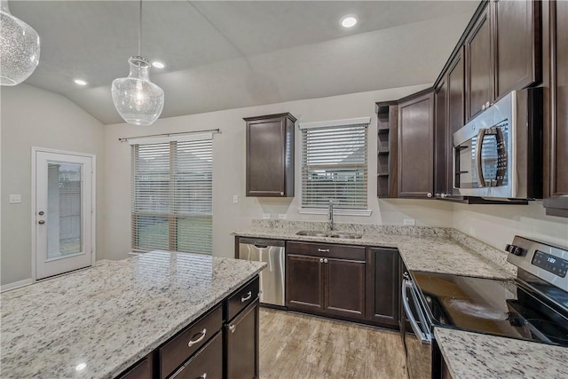 kitchen with lofted ceiling, dark brown cabinets, and appliances with stainless steel finishes