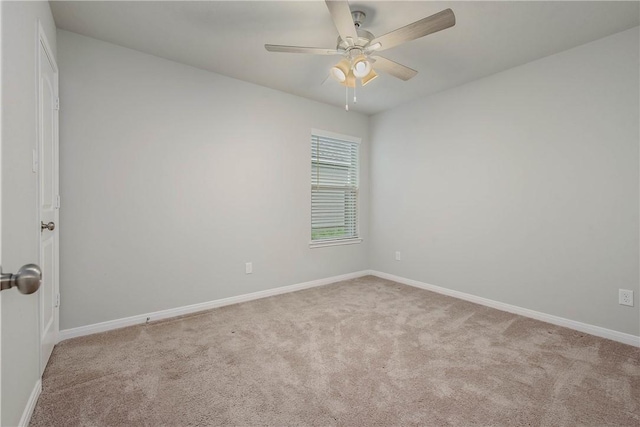 spare room with carpet flooring, ceiling fan, and baseboards