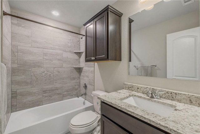 bathroom with toilet, vanity, visible vents, and shower / bathtub combination