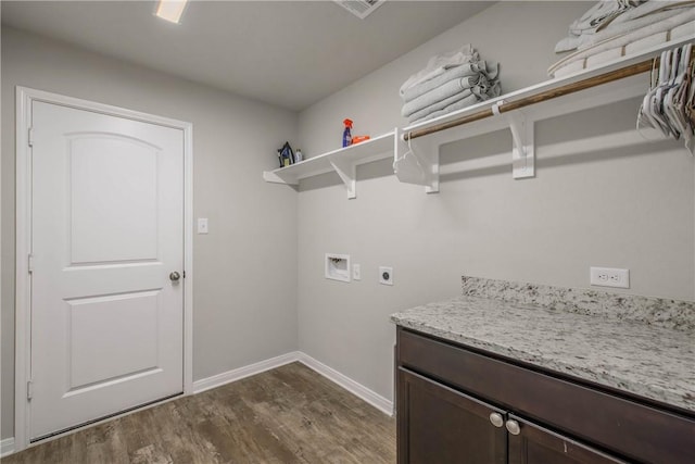 laundry area featuring washer hookup, dark wood finished floors, cabinet space, electric dryer hookup, and baseboards