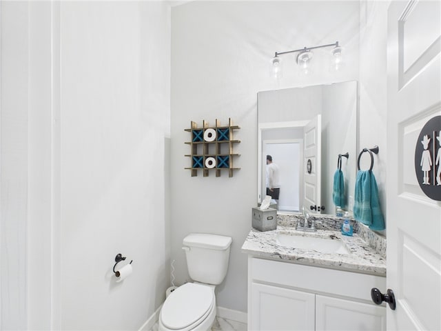 3903 Brownway Ct, College Station, TX 77845 - half bathroom featuring vanity, toilet, and baseboards