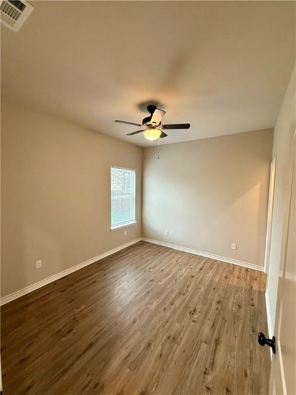 unfurnished room featuring hardwood / wood-style flooring and ceiling fan